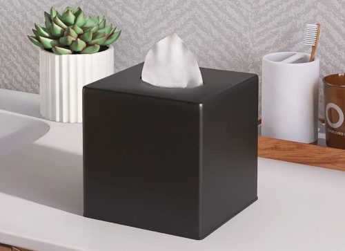 A Black Countertop Tissue Box Cover Placed White Surface Table.