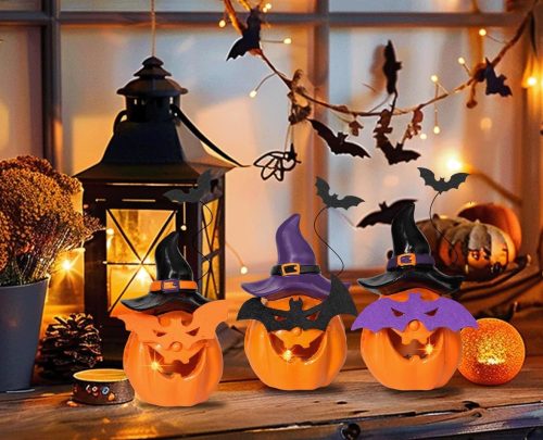 Battery Operated Lighted Pumpkin with Spooky Face Displayed on the Table.